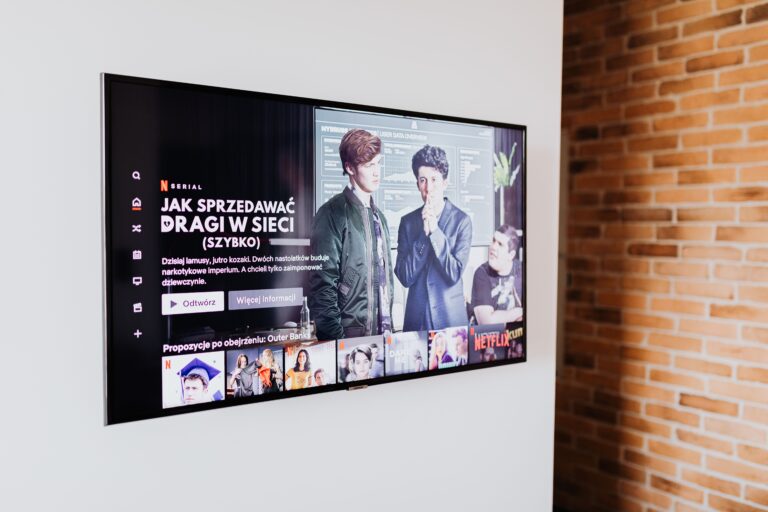 Smart TV mounted on a living room wall displaying streaming content