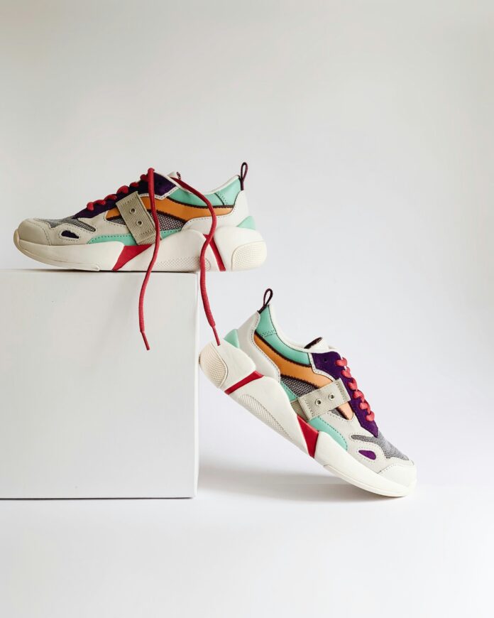 photo-1560769629-975ec94e6a86 Pair of running shoes on a white box