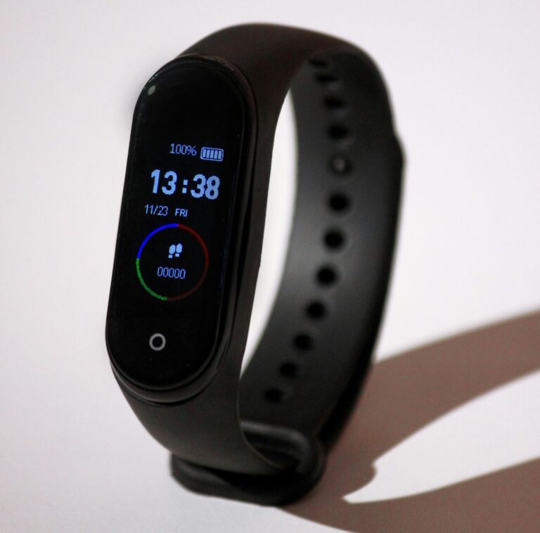 Close-up of a fitness tracking smartwatch on a wrist, showing the kind of activity and heart-rate tracking display covered in this buying guide.